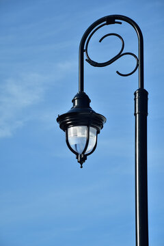 Black architectural pole street light with blue sky