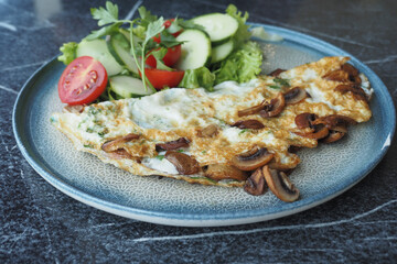 Plain Egg Omelette and fresh salad on table 