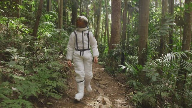 Boy in a Space Suit Costume walking somewhere in the jungle