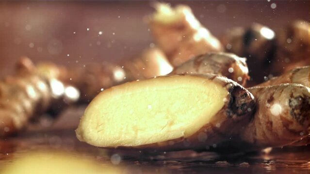 A knife cuts through fresh ginger. Filmed on a high-speed camera at 1000 fps. High quality FullHD footage
