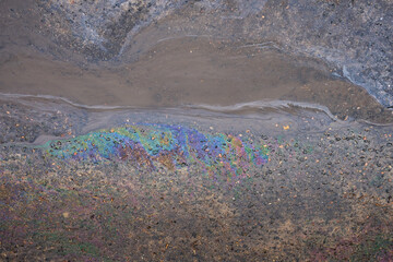 Beautiful abstract stain of motor oil, gas or petrol spilled on the asphalt