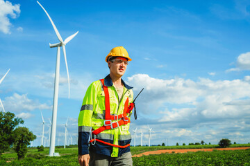 Engineer inspects wind turbine at wind farm for maintenance