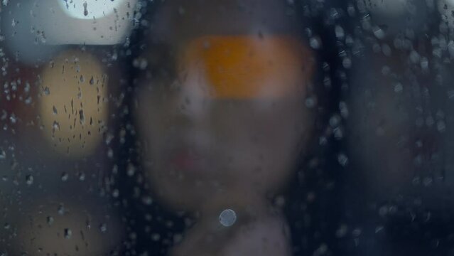 Thoughtful Young Woman Thinking about Life Outside in the Rain at Night