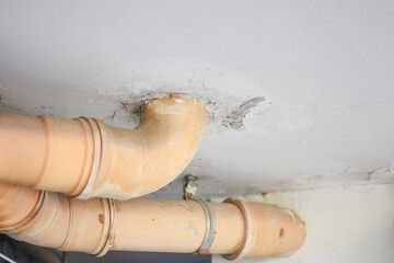 Yellow sewer pipe under the building