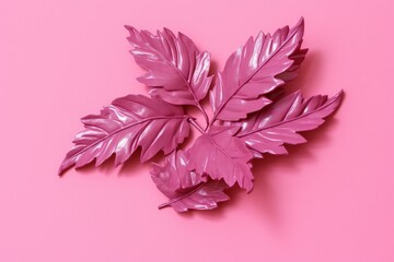 Creative layout made of tropical leaves on pink background