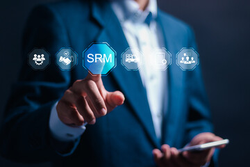 SRM, Supplier Relationship Management concept. Businessman touching virtual screen of SRM icon for cooperation business, supplier, risk management, strategy, contract and optimization.
