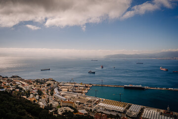 Fototapeta na wymiar Gibraltar, Britain - January 24, 2024 - vast view of the sea with multiple ships near Gibraltar, the city, and a distant mountain range.