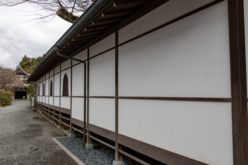 Window on white wall in Sanzen-in temple in Kyoto, Japan
