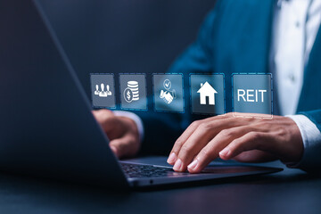 REIT, Real estate investment trust concept. Businessman use laptop with virtual reit icons for real...