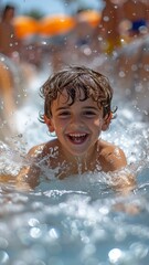 Obraz premium Children enjoying themselves as they slide in the water park.