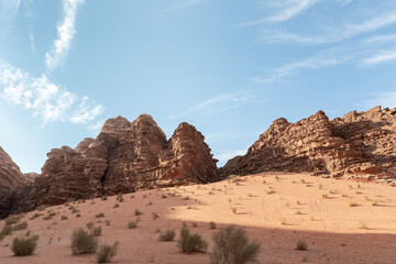 Fototapeta premium Beautiful high mountains in the endless sandy red desert of the Wadi Rum near Amman in Jordan