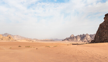 Fototapeta na wymiar The enchanting beauty of the endless sandy red desert of Wadi Rum near Amman in Jordan