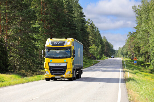 Yellow DAF XF Truck Semi Trailer Delivers Goods along Highway on Sunny Summer Morning