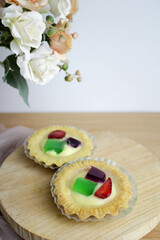Fruit Pie served on wooden board in white background. A healthy dessert dish with cream cheese filling, garnished with strawberry and jelly.