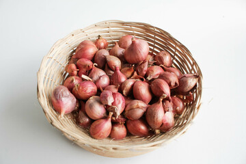 Red onion cloves on a rattan wicker