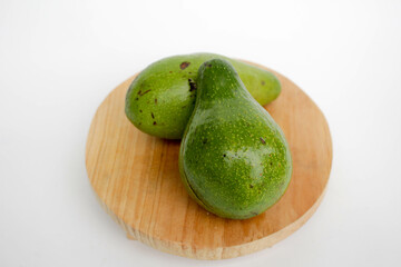 Avocado served on wooden board, isolated on white background. 