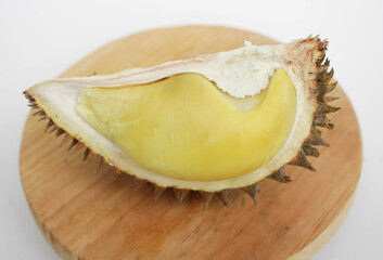 Durian fruits served on wooden board, isolated on white background