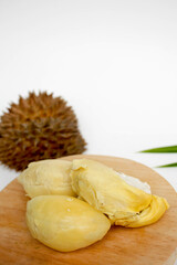 Durian fruits served on wooden board, isolated on white background