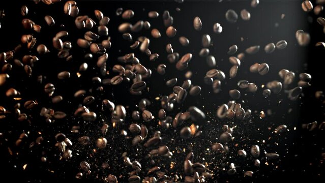 Coffee beans fly in different directions. On a black background. Filmed on a high-speed camera at 1000 fps. High quality FullHD footage