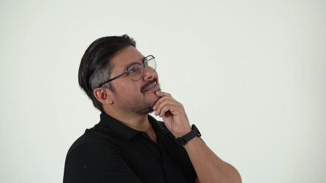 A creative man thinking, visualizing new ideas and concepts. A middle aged guy, side view, isolated on a white background. 30 fps, 50 percent speed.