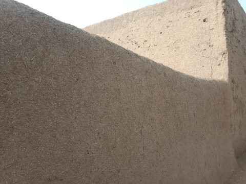 A wall made of pure mud or and straw in village.pure mud wall brown background