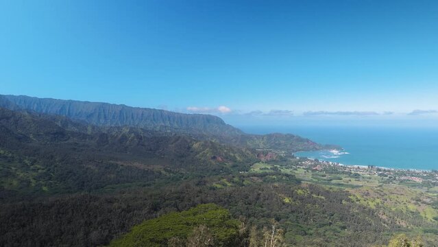 breathtaking aerial view of the stunning Hanalei Bay from the lofty heights of Kauai. This footage captures the bay's serene beauty, surrounded by lush landscapes and the sparkling ocean
