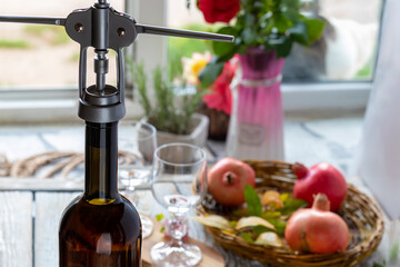 Opening wine bottle. Close-up of neck of wine bottle with corkscrew. Wine Bottle, selective focus,...