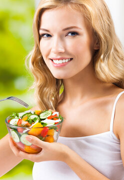 Portrait image - happy smiling young woman with vegetable salad at home house, indoors. Healthy eating, vegetarian, keto ketogenic diet concept.