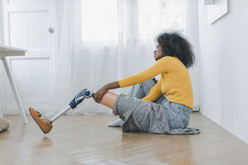 Woman with prosthetic leg doing physical therapy exercise at home. Woman wearing prosthetic equipment for walking. - obrazy, fototapety, plakaty