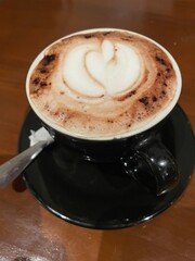 A cup of delicious hot chocolate on the wooden table