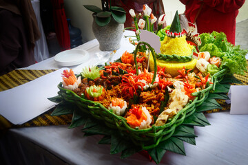 Tumpeng or tumpeng rice is a dish served at Javanese, Balinese, Madurese and Sundanese traditional...