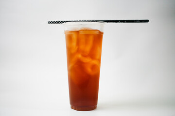 Take away iced tea in plastic cup with straw isolated on white background
