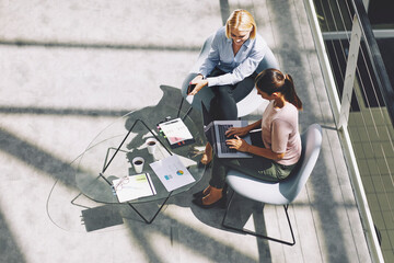 Businesswomen having a meeting while typing on a laptop