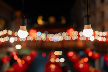 Warm light bulbs line the walkway with bokeh in the background. During the Chinese New Year...