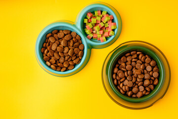 Bowl with dry pet food on yellow background studio shot © fotofabrika