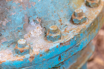 Rusty bolts on a metal pipe