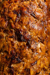 Closeup of kebab meat cooking in a souvlaki shop.