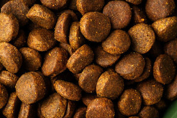 Dry pet food granules for background top view