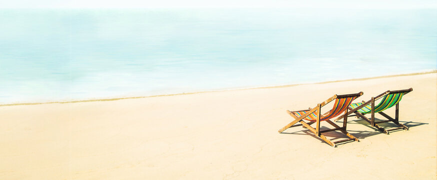Lounge chairs on a tropical beach at summer