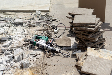 Jackhammer repair of pedestrian road, asphalt and tile re-laying