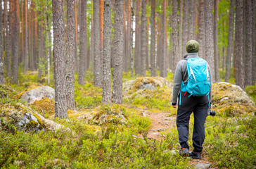 woman with a backpack hiking in forest