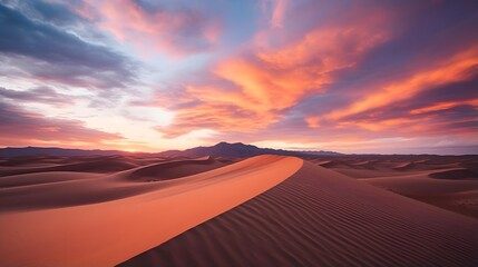 Fototapeta na wymiar Panoramic view of the sand dunes in the desert at sunset