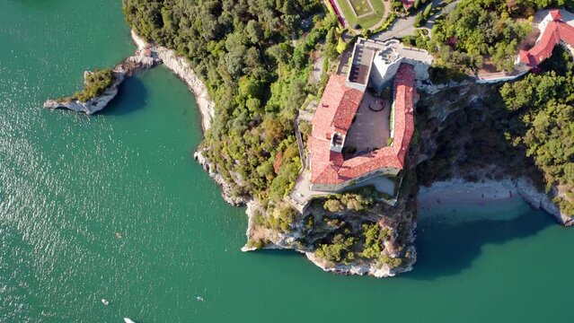 4k drone flying over footage (Ultra High Definition) of Duino Castle. Fantastic morning scene of Adriatic coast of Italy, Europe. Beautiful cityscape of Duino town. Traveling concept background..