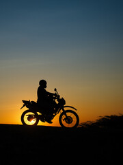 Obraz na płótnie Canvas Motorcyclist at sunset