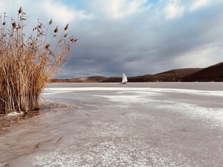 Fototapeta na wymiar Frozen lake and ice sailing