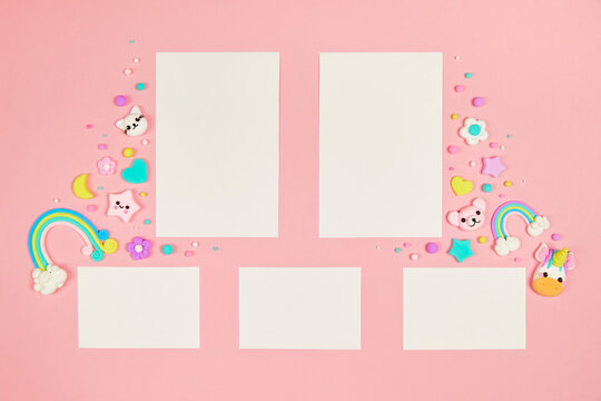 Set of five blank white cards on pastel pink background with frame of cute kawaii air plasticine handmade cartoon animals, rainbows. Empty photo frames, baby's photo book, scrapbooking design template