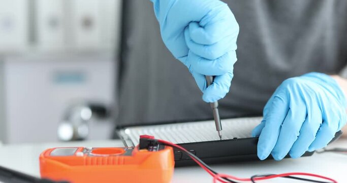 Male hands are repairing and unscrewing oled lamp. Repair of lighting electrical equipment concept