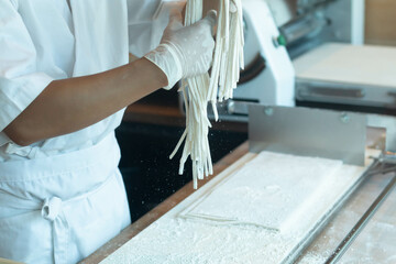 Chef making raw udon japanese noodle