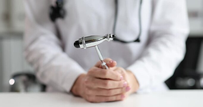 Professional doctor holds neurological hammer in hands. Neurologist consultation concept