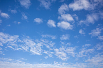 Naklejka na ściany i meble White clouds in a bright blue sky